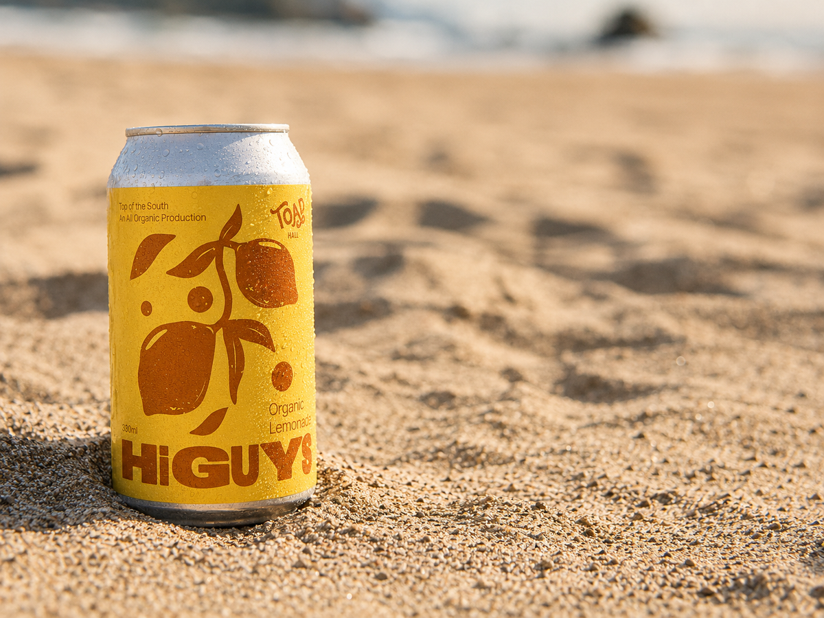 Hi Guys Organic Lemonade can on a sandy beach